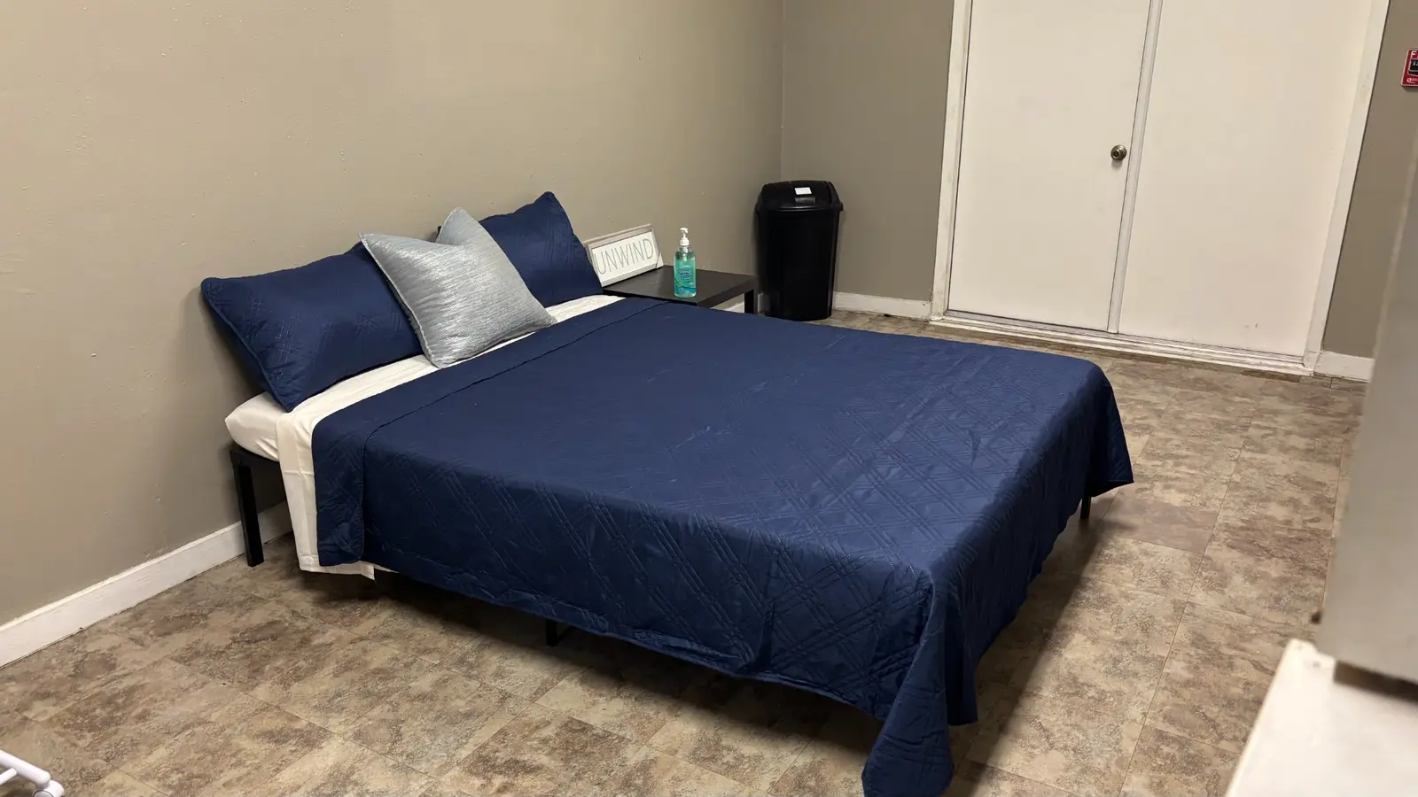 A furnished bedroom prepared for a housing resident