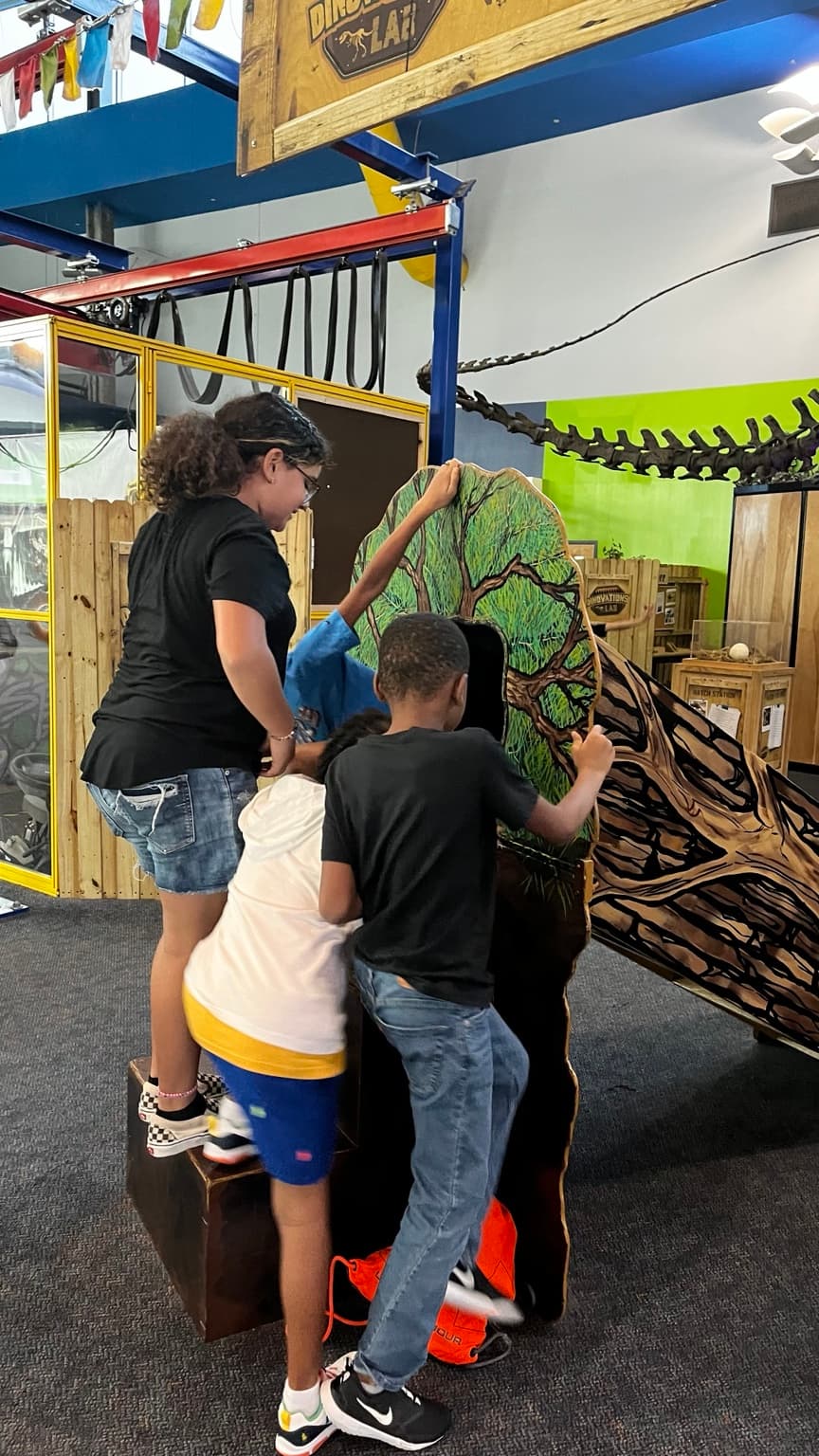 Young people exploring an interactive learning exhibit